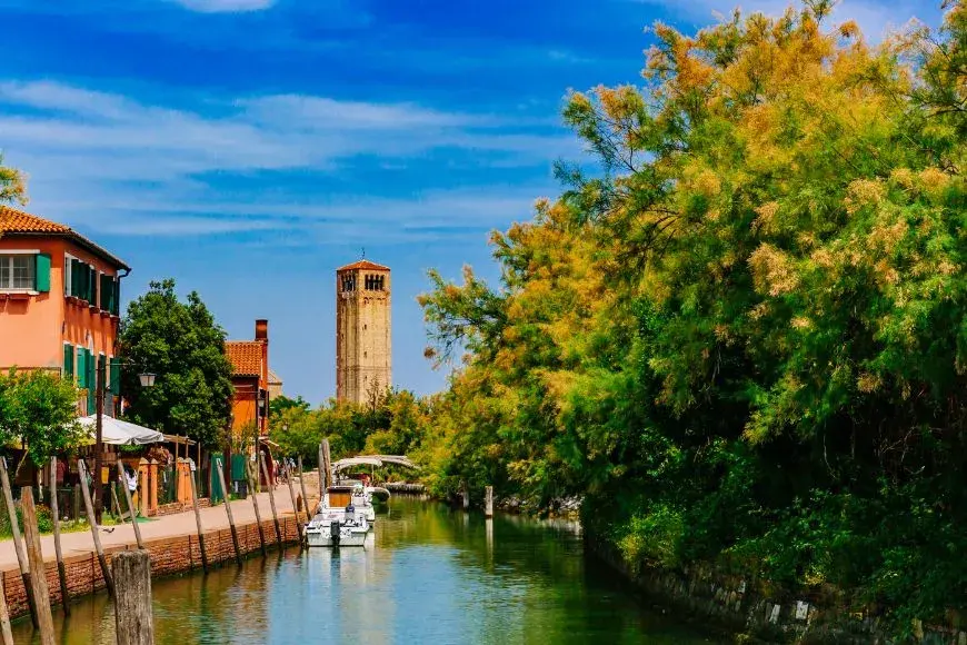 Venice Travel Guide, Bell Tower of Torcello Cathedral Over Canal and Trees on Torcello island