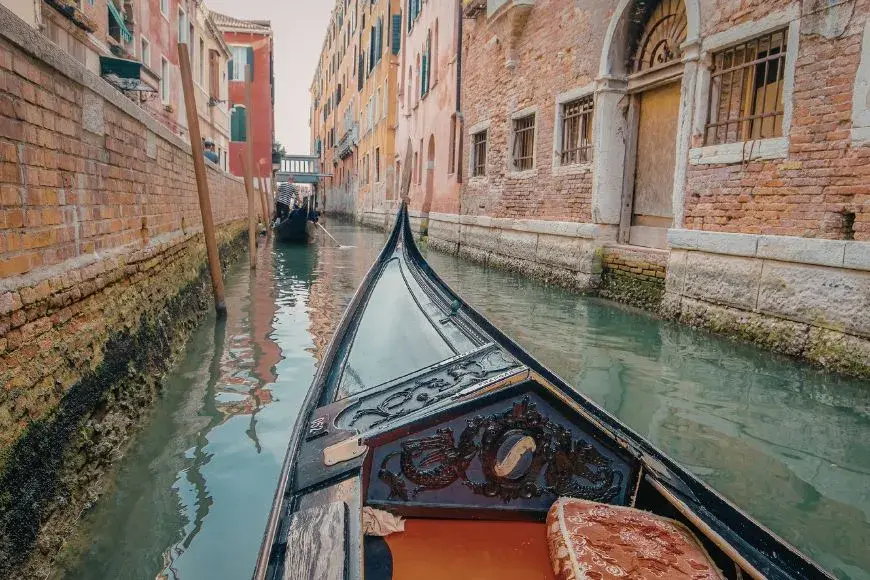 Venice Travel Guide, Gondola Floating in a Narrow Venetian Canal 