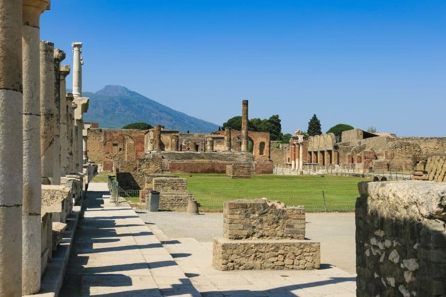 Day Trips From Naples, Stone street ruins of Pompeii with Mount Vesuvius in the background