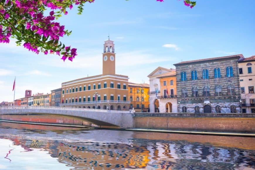 Pisa Travel Guide, Arno River waterfront in Pisa with colorful buildings and bridges