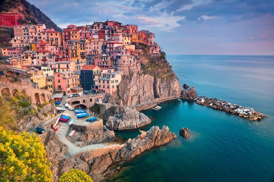 2 Days in Cinque Terre, Manarola harbor with boats and terraced vineyards above the sea