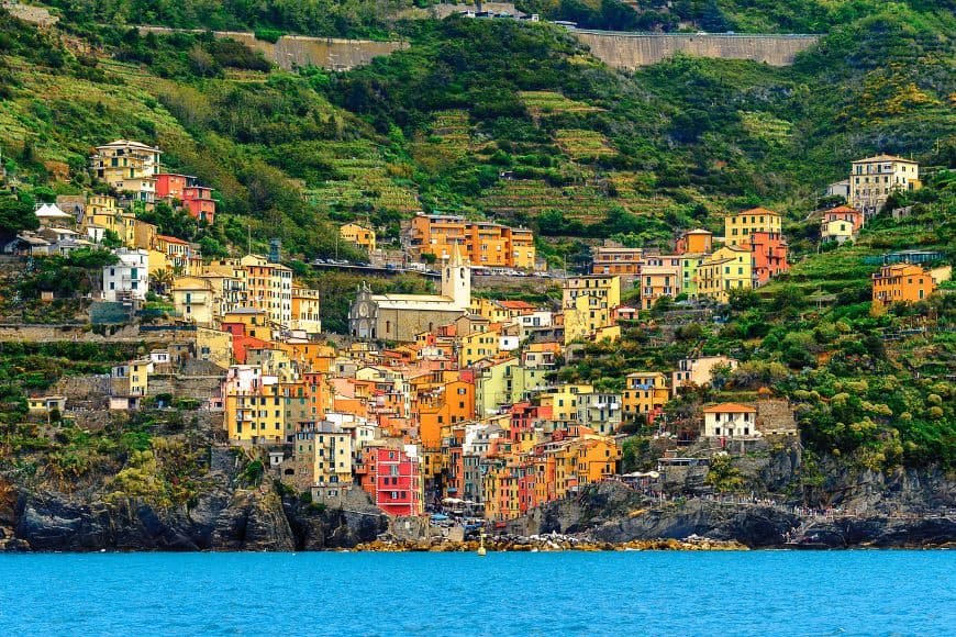 Cinque Terre Travel Guide, Riomaggiore harbor with cliffside houses in Cinque Terre Italy
