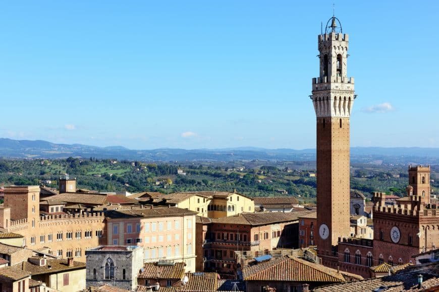 Siena Travel Guide, Torre del Mangia tower view over Siena rooftops