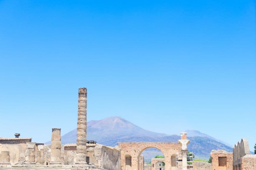 Ancient Roman ruins of Pompeii with Mount Vesuvius rising in the background, Day Trips From Rome