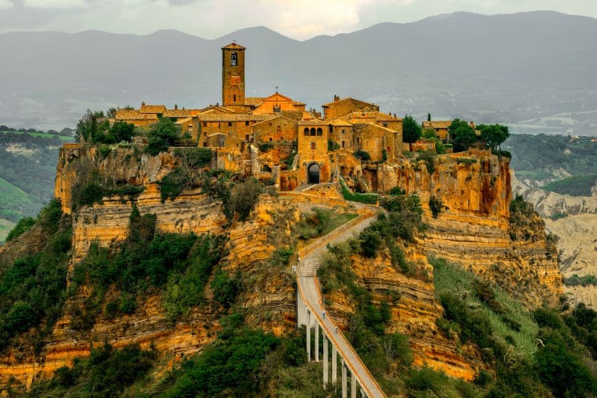 Civita di Bagnoregio medieval hilltop village connected by a pedestrian bridge. Day Trips From Rome