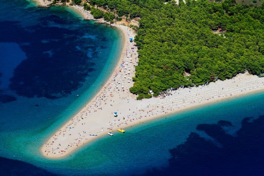 Zlatni Rat pebble beach surrounded by turquoise Adriatic waters on Brač Island, Day Trips From Split